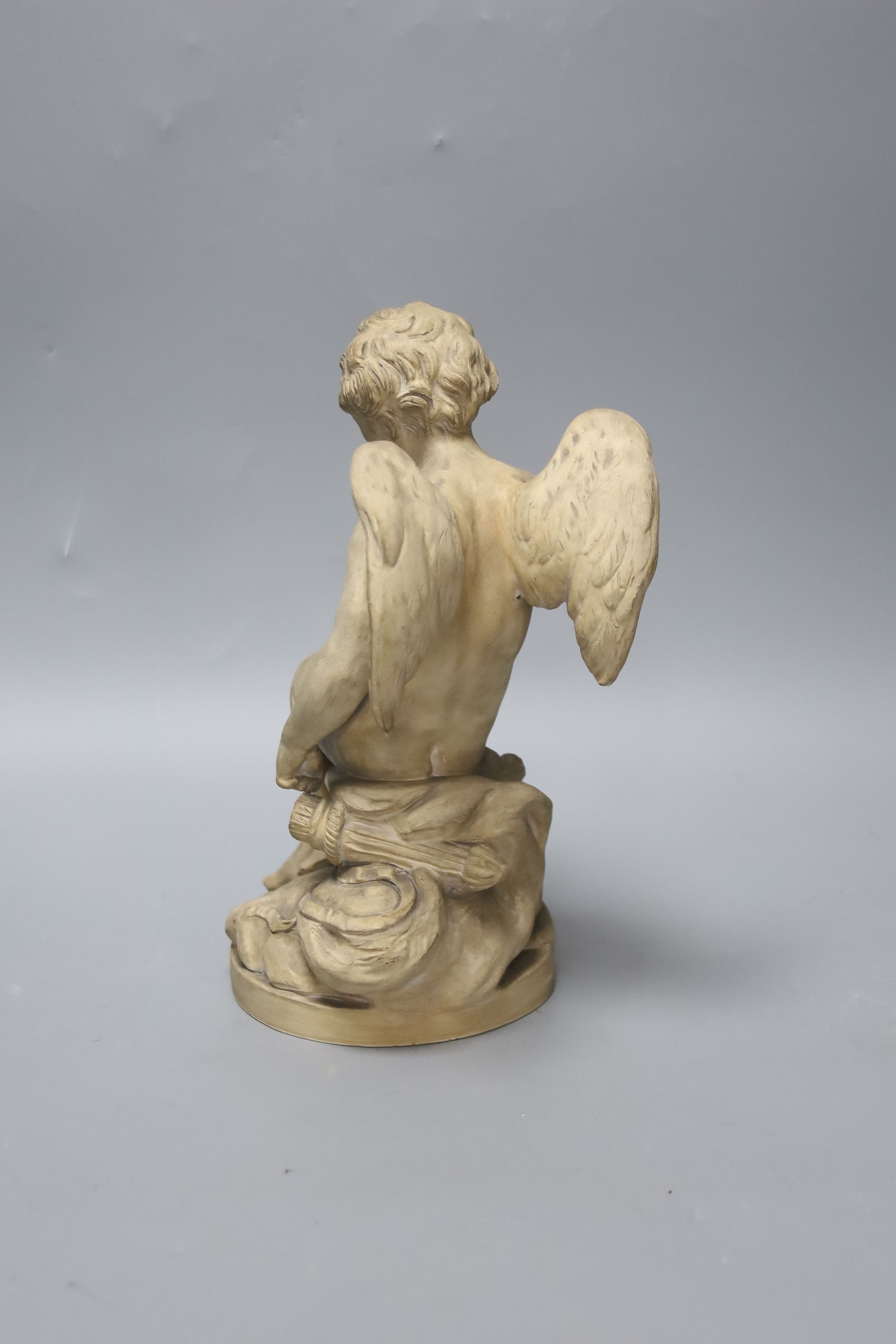 A Sevres style terracotta figure of Cupid, 25cm